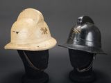 two helmets are sitting on top of each other on a black surface