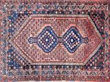 an antique persian rug with a blue and red design