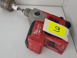 a drill and a hammer on a shelf in a room
