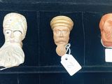 three different types of heads are on display in a display case