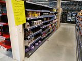 many shelves in the store that have items on them