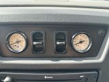 two gauges on the dash of a car ' s dashboard