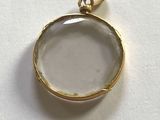 an image of a close up of a glass pendant on a white surface