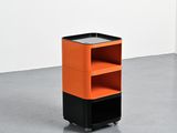 an orange and black shelf with two shelves on wheels in a room