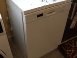 an image of a kitchen with a refrigerator and a washing machine