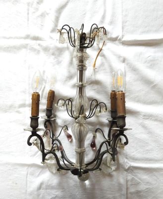 a chandelier that has three lights on it