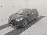 a grey car is parked in a white room with a checkered floor