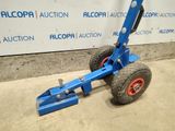 a close up of a blue hand truck with a red wheel