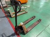 a fork lifter sitting on the floor in a warehouse