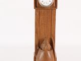 a wooden clock with a cat on the front of it