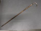a metal stick with a long handle on a table