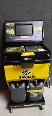 a black and yellow machine with a yellow box on it