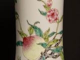 a white vase with a bird and flowers painted on it