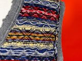 a close up of a woman ' s top with a colorful pattern
