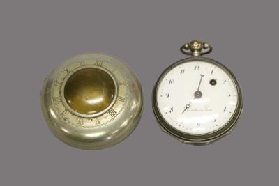 a silver pocket watch and a gold pocket watch on a gray background
