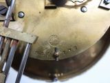 a close up of a clock that has a fork in it