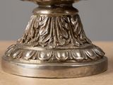 a silver plate with a bird on it on a table