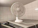 a fan sitting on top of a counter in a kitchen