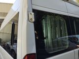 a white van that is parked next to a building