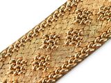 gold leather bracelet with a braided design on a white background