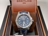 the watch is in a box with a brown leather strap