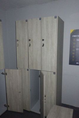 Plusieurs casiers sont alignés dans une pièce où est accrochée une affiche au mur