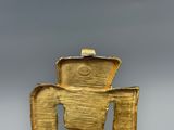 yellow ceramic sculpture of a man with a hat on top of his head