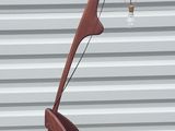 a sculpture made of wood and metal on the sidewalk