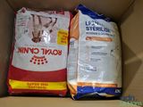 two bags of cat food in a cardboard box