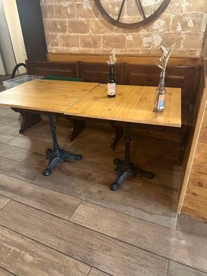 a wooden table with two bottles of wine on it