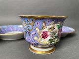 three cups and saucers sitting on a table