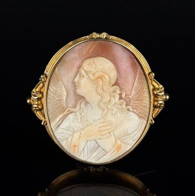 an image of a gold ring with a picture of an angel