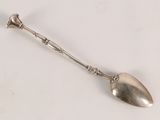 a spoon that is sitting on a white surface