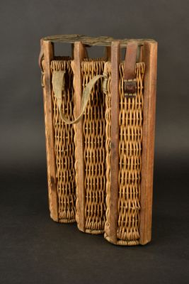 two wooden baskets with handles on a black background