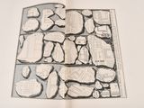 an open book with a drawing of rocks on it
