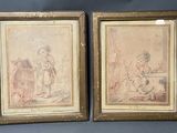 deux tableaux encadrés représentant un homme et une femme assis sur un canapé