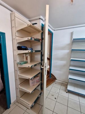 a large open shelf in the corner of a room