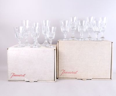 several empty wine glasses sitting in a box on a white surface