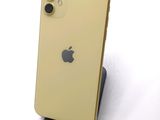 an iphone 11 is sitting on top of a stand on a white surface