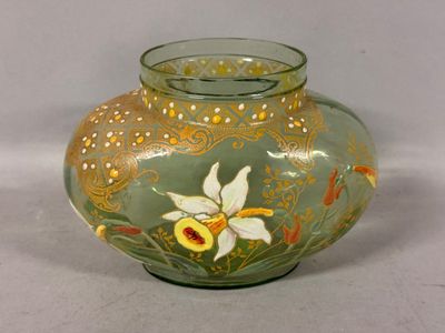 a glass vase with a flower on it on a table