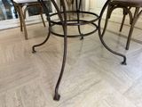 a glass table with four chairs around it in a room