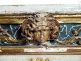 a gold statue on a marble table with a lion head on it