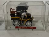 a small model of a car in a glass case