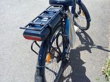 a bicycle parked on the side of the road with a basket on the back of the bike