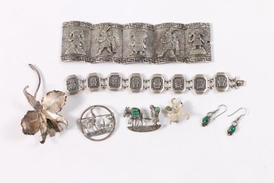 several pieces of silver jewelry including a bracelet, broochle, and earrings