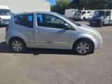 a small silver car that is parked in a parking lot
