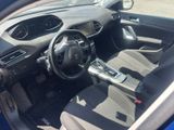 the interior of a blue car with a steering wheel and dashboard