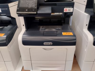 several multi - function printers are lined up in a row on the floor