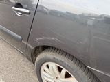 a car that has been dented and is parked on the side of the road