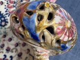 a figurine of a turtle with a bell on it ' s head
